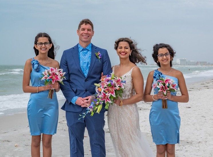 man standing with 3 girls